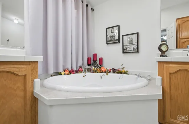 a bath tub sitting next to a bathroom sink