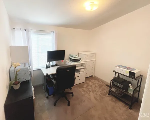 a spacious bedroom with a bed and window