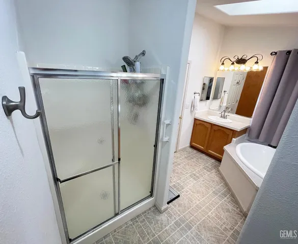 a bathroom with a shower and a mirror