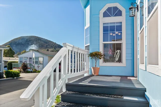 a view of staircase with white walls and a rug