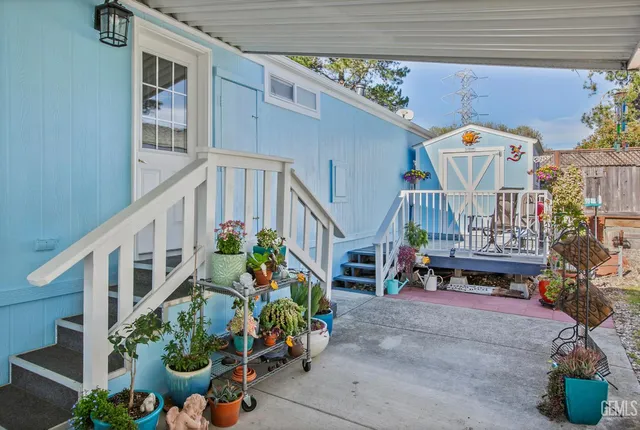 a balcony with lots of yellow flowers and plants