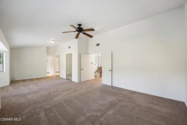 a view of empty room with ceiling fan