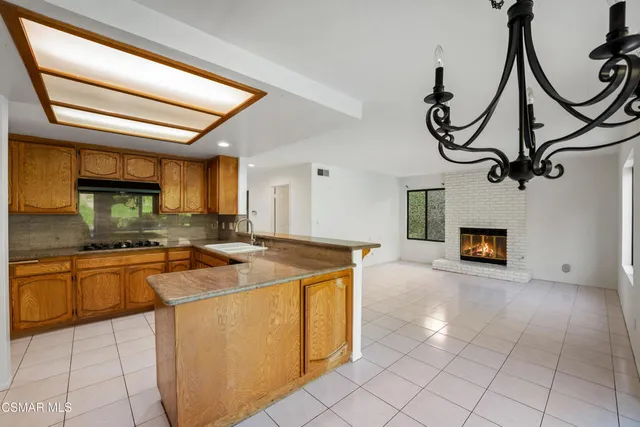 a kitchen with stainless steel appliances granite countertop a granite counter tops and a view of living room