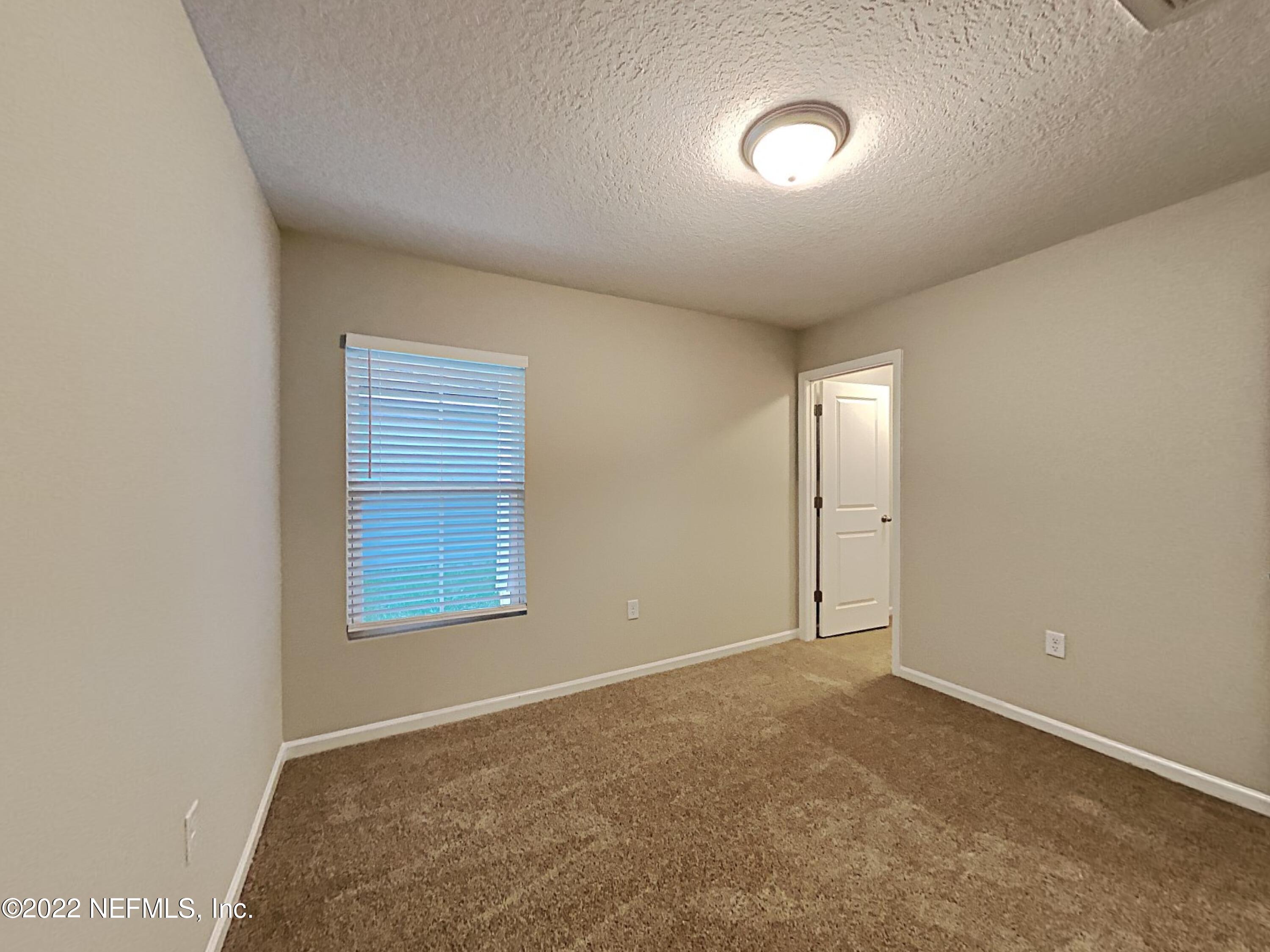 1562 Liberty Tree Place Jacksonville, FL 32221 - Photo 14 of 19 an empty room with windows and fan