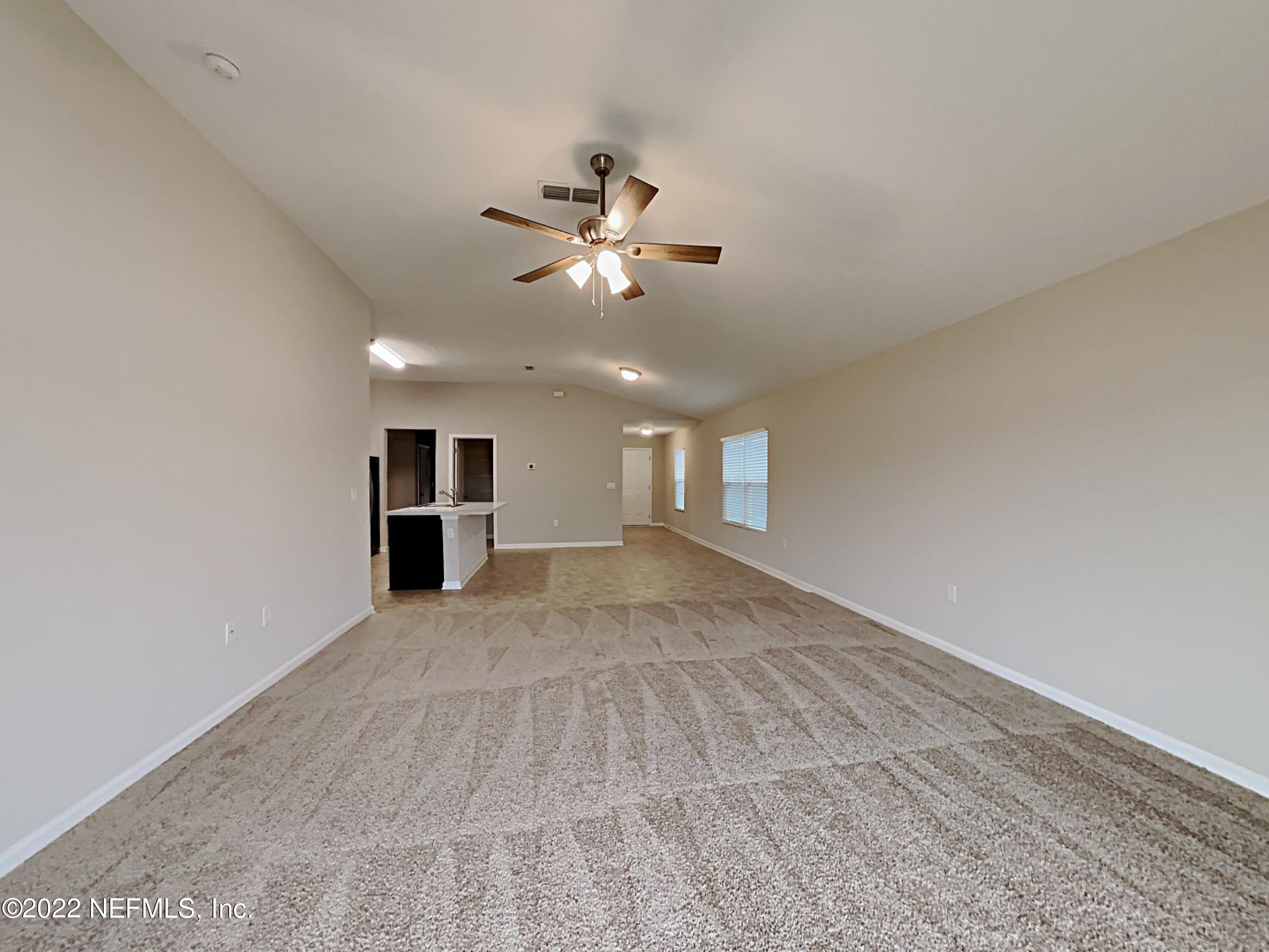 1562 Liberty Tree Place Jacksonville, FL 32221 - Photo 2 of 19 a view of empty room with wooden floor and ceiling fan