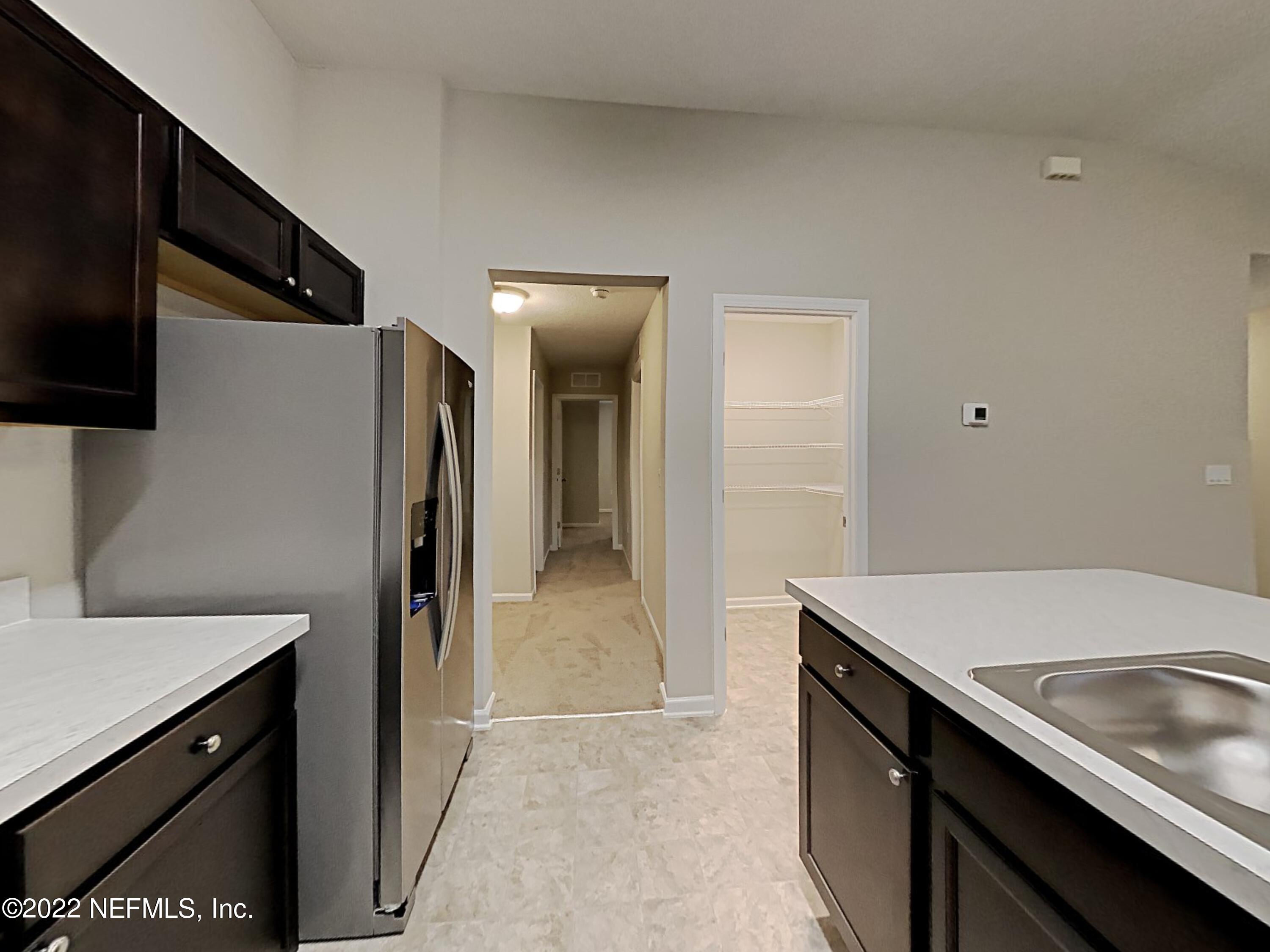 1562 Liberty Tree Place Jacksonville, FL 32221 - Photo 6 of 19 a kitchen with a sink appliances and cabinets