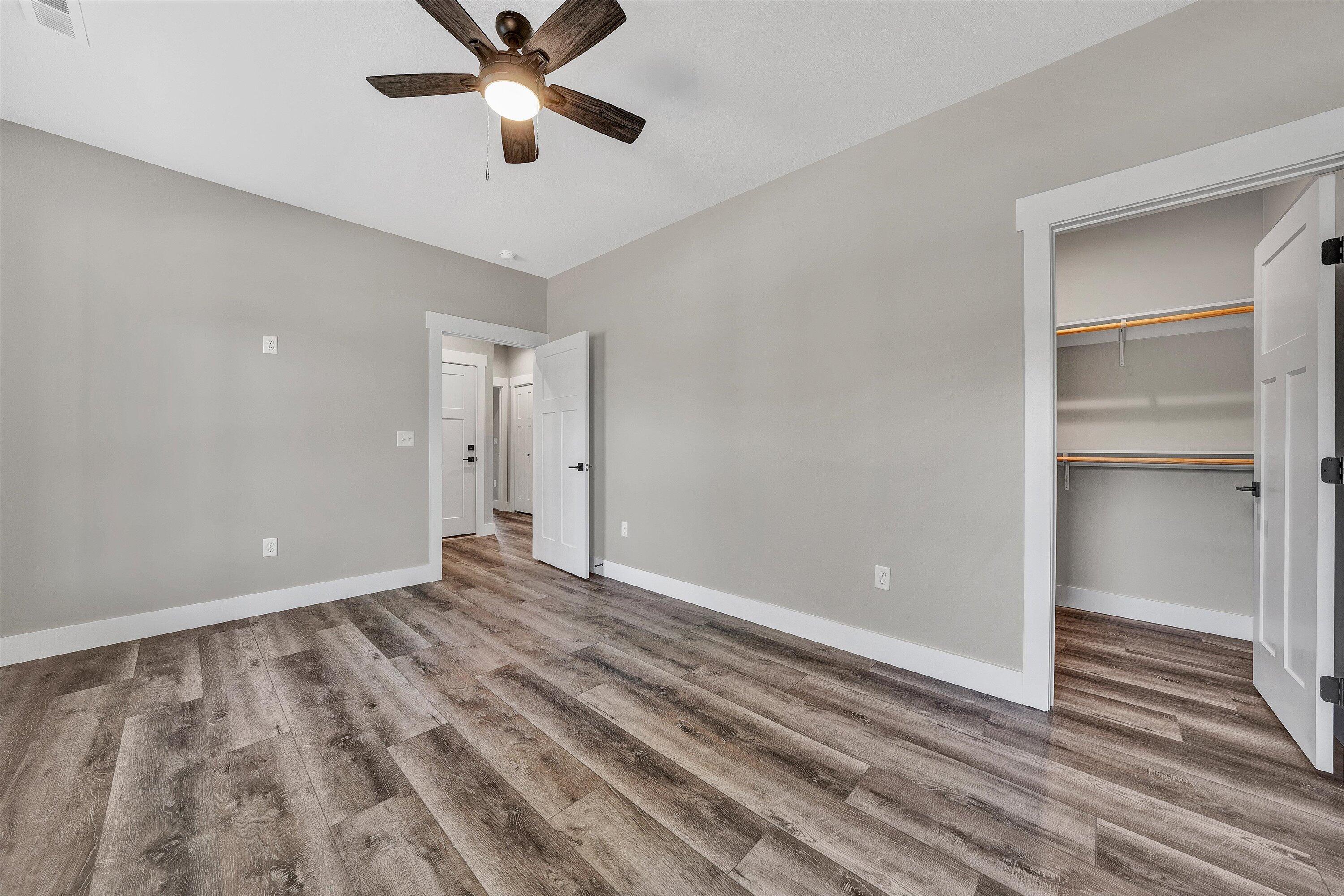 6450 Scruggs Road Moneta, VA 24121 - Photo 11 of 42 a view of an empty room with wooden floor and a ceiling fan