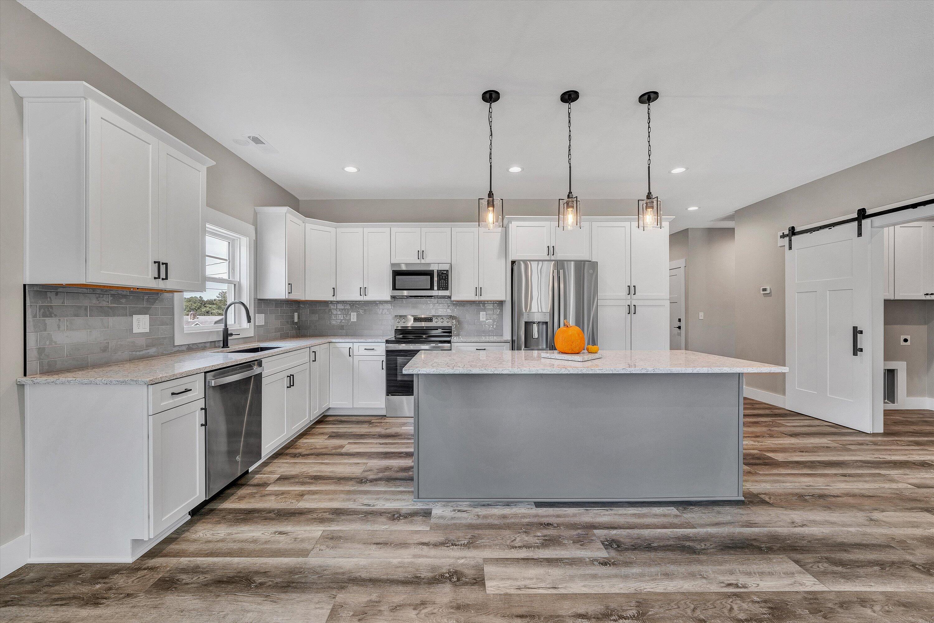 6450 Scruggs Road Moneta, VA 24121 - Photo 14 of 42 a large kitchen with stainless steel appliances and white cabinets