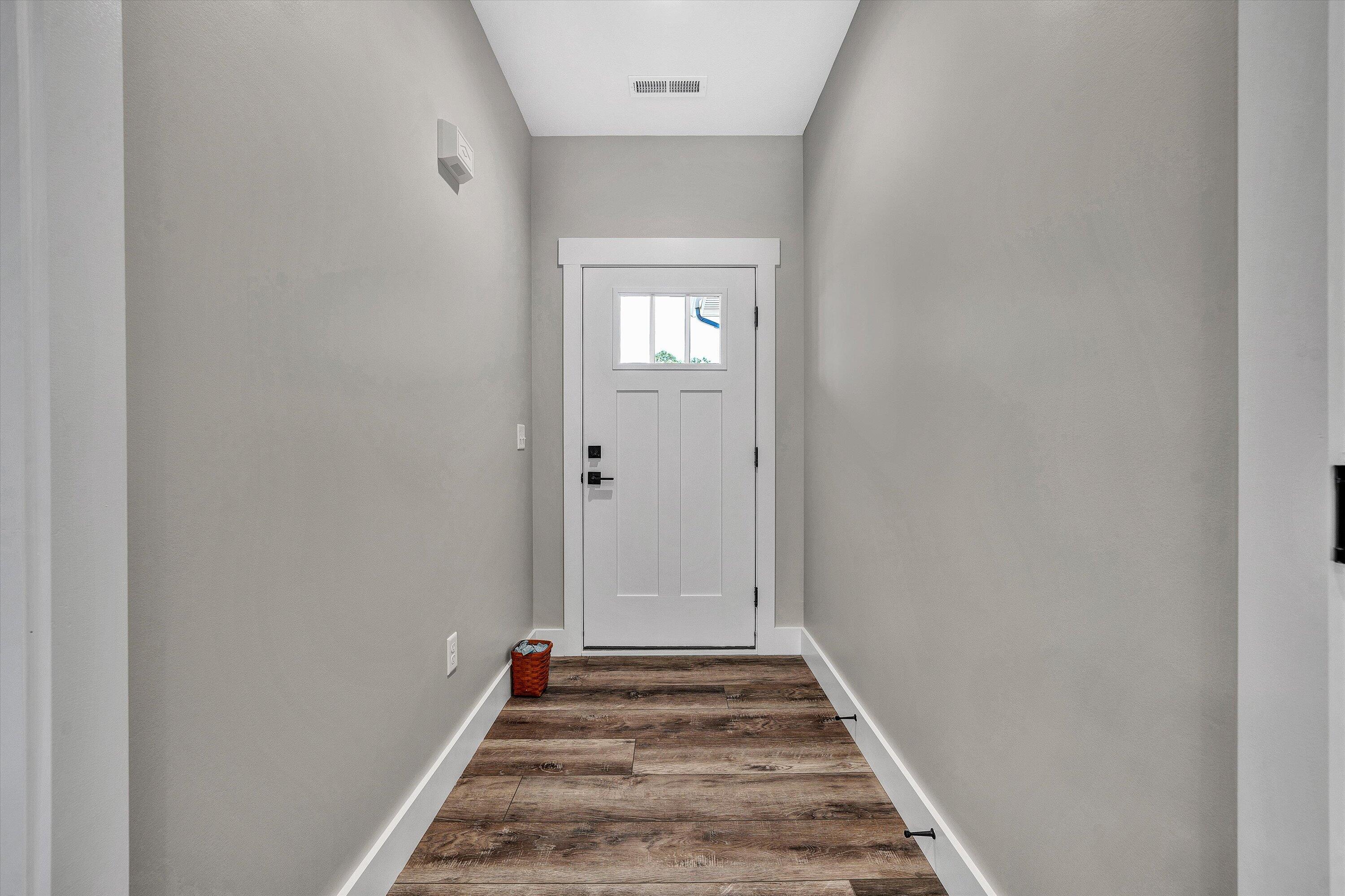 6450 Scruggs Road Moneta, VA 24121 - Photo 7 of 42 a view of a hallway with wooden floor and a bathroom
