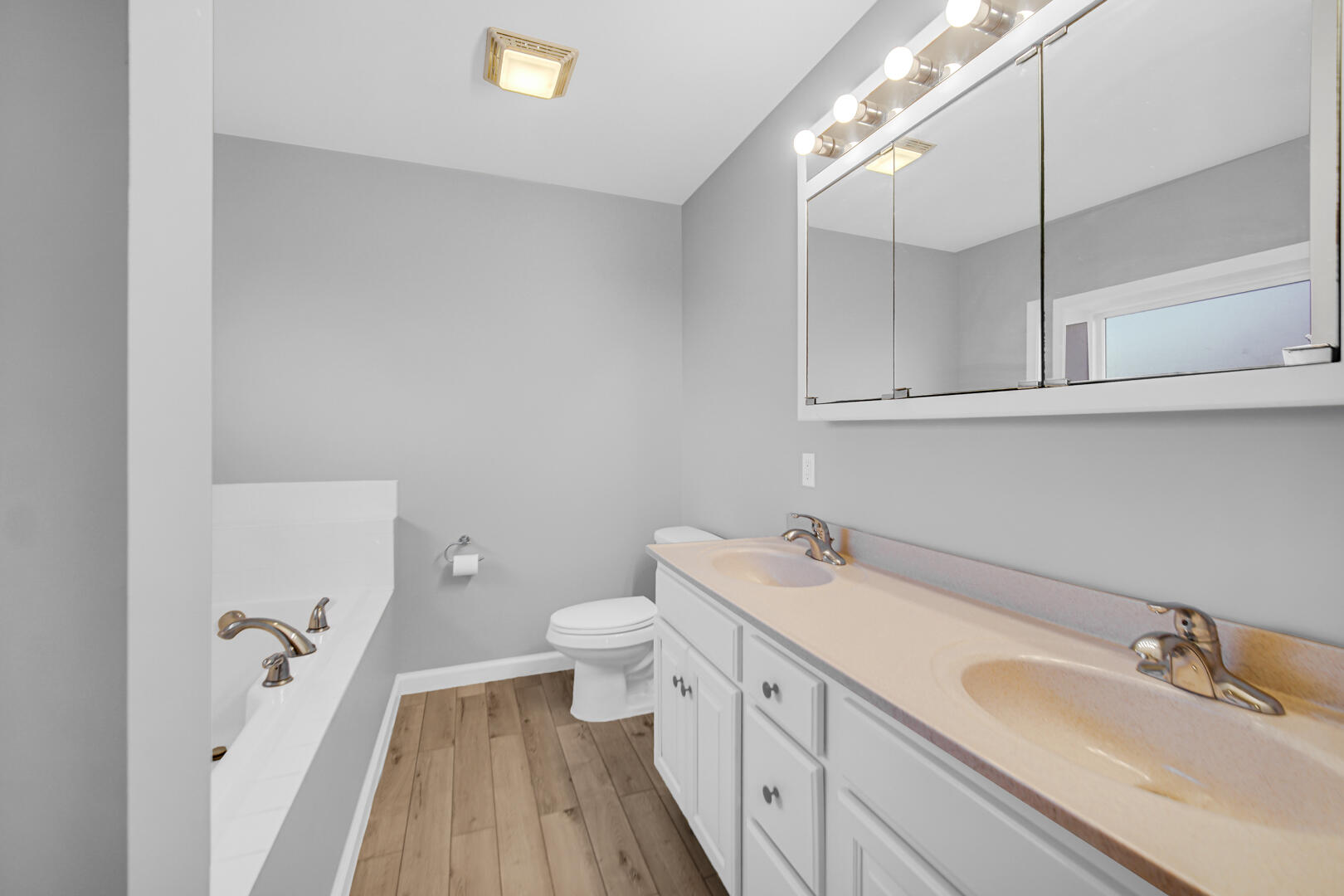 3429 East Sand Ridge Road Rolling Prairie, IN 46371 - Photo 14 of 25 a bathroom with a sink and mirror with toilet