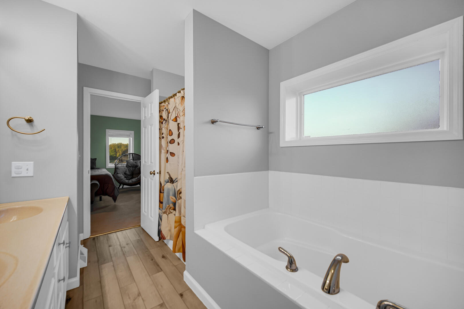 3429 East Sand Ridge Road Rolling Prairie, IN 46371 - Photo 15 of 25 a bathroom with a tub a sink and a window