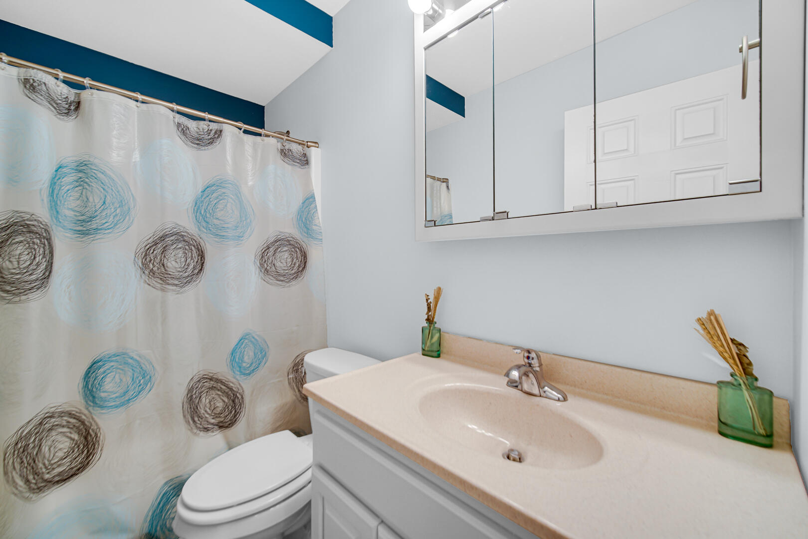3429 East Sand Ridge Road Rolling Prairie, IN 46371 - Photo 17 of 25 a bathroom with a sink a toilet and a shower curtain