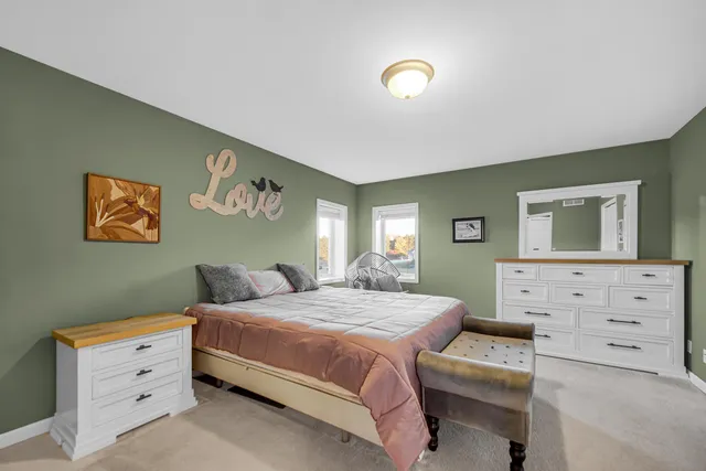 a bedroom with a bed and a dresser