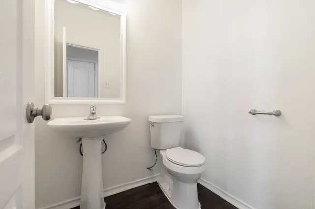 a bathroom with a sink toilet and a mirror