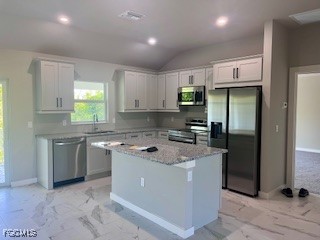14058 Pacosin Court Bokeelia, FL 33922 - Photo 2 of 13 a kitchen with kitchen island granite countertop a sink a counter top space and stainless steel appliances