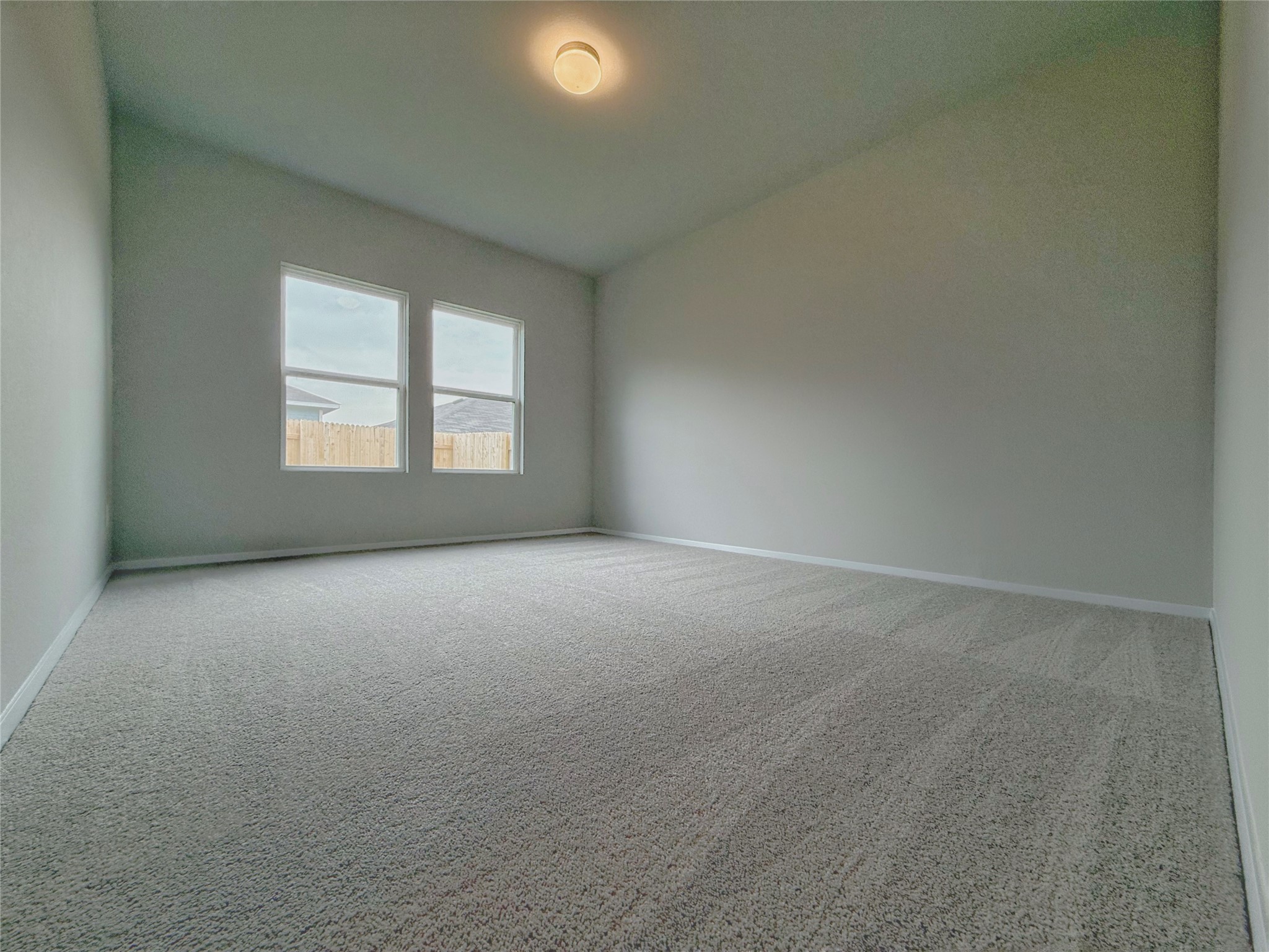 2714 Towy Road Manor, TX 78653 - Photo 9 of 22 A quiet retreat with plush carpeting awaits, offering a tranquil space with abundant natural light.