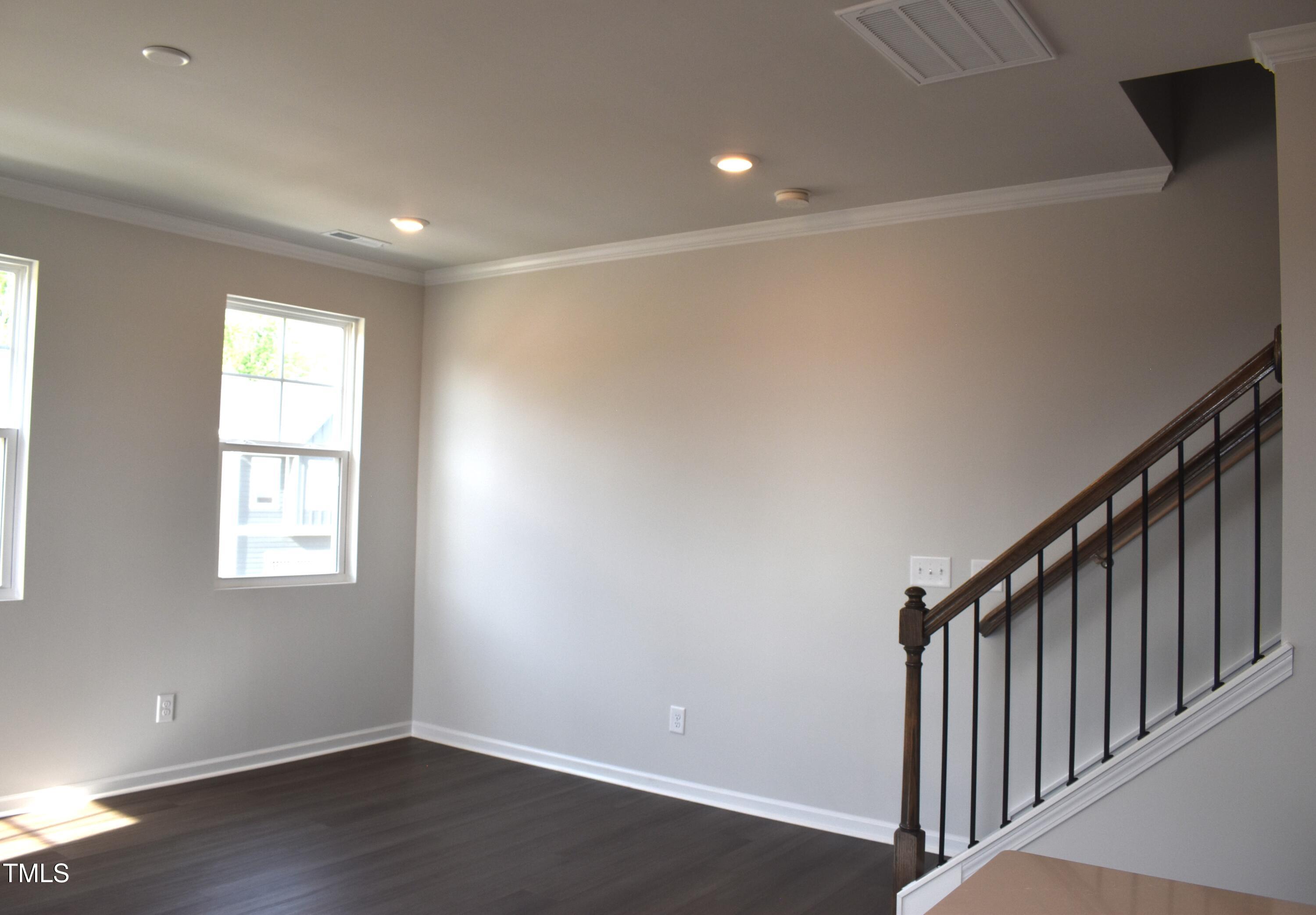 301 Deercroft Drive Apex, NC 27539 - Photo 12 of 33 a view of an empty room with wooden floor and a window