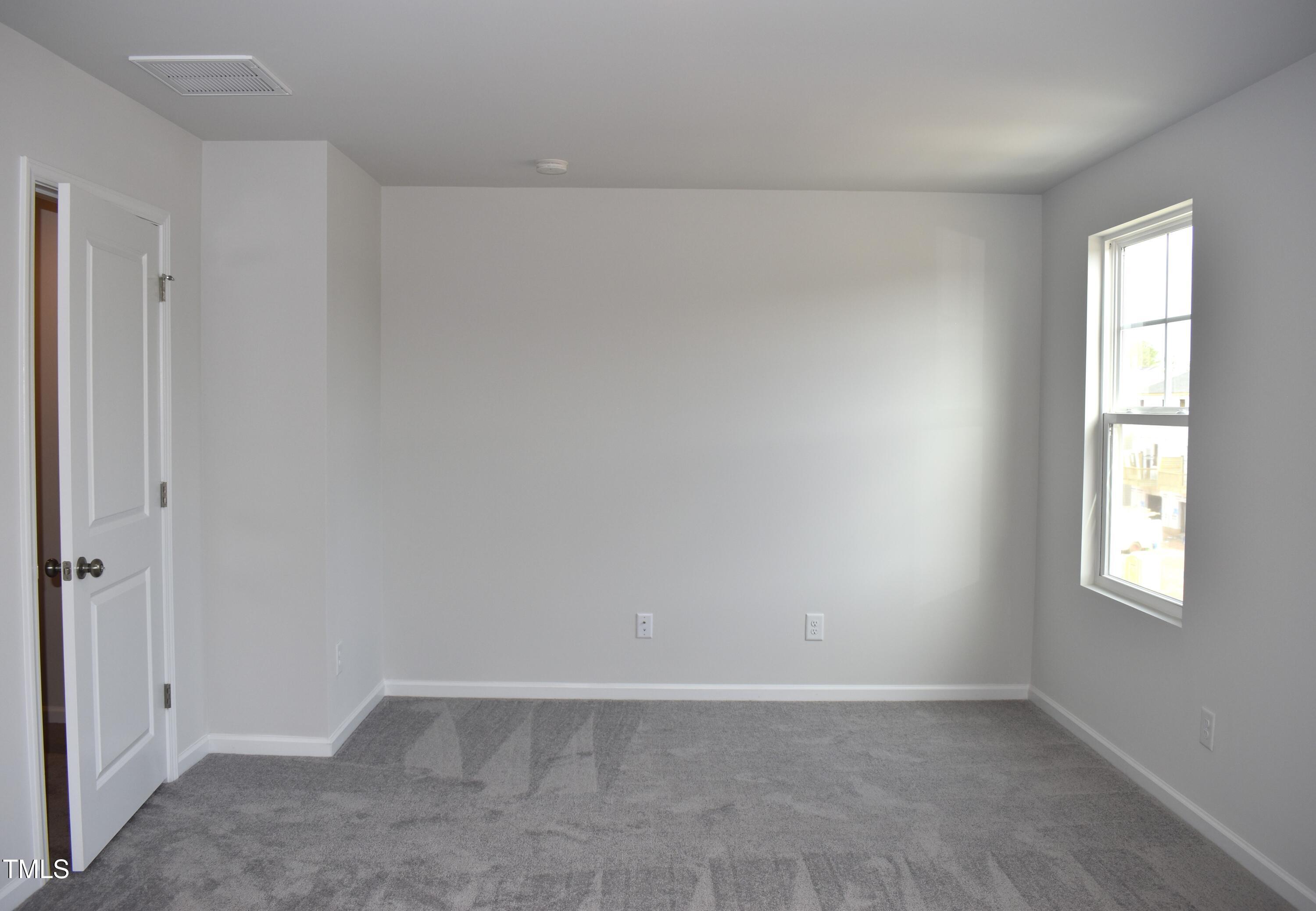 301 Deercroft Drive Apex, NC 27539 - Photo 21 of 33 an empty room with windows and closet
