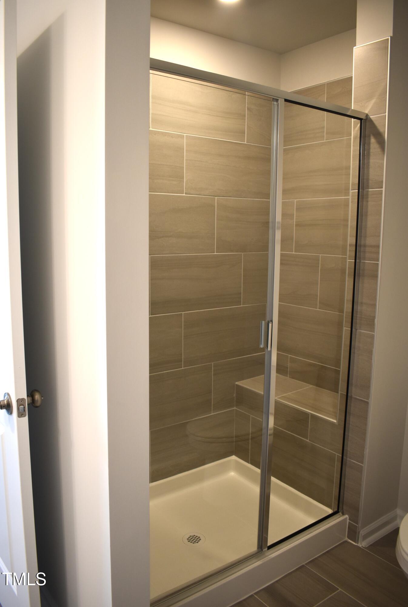 301 Deercroft Drive Apex, NC 27539 - Photo 24 of 33 a bathroom with a glass shower door