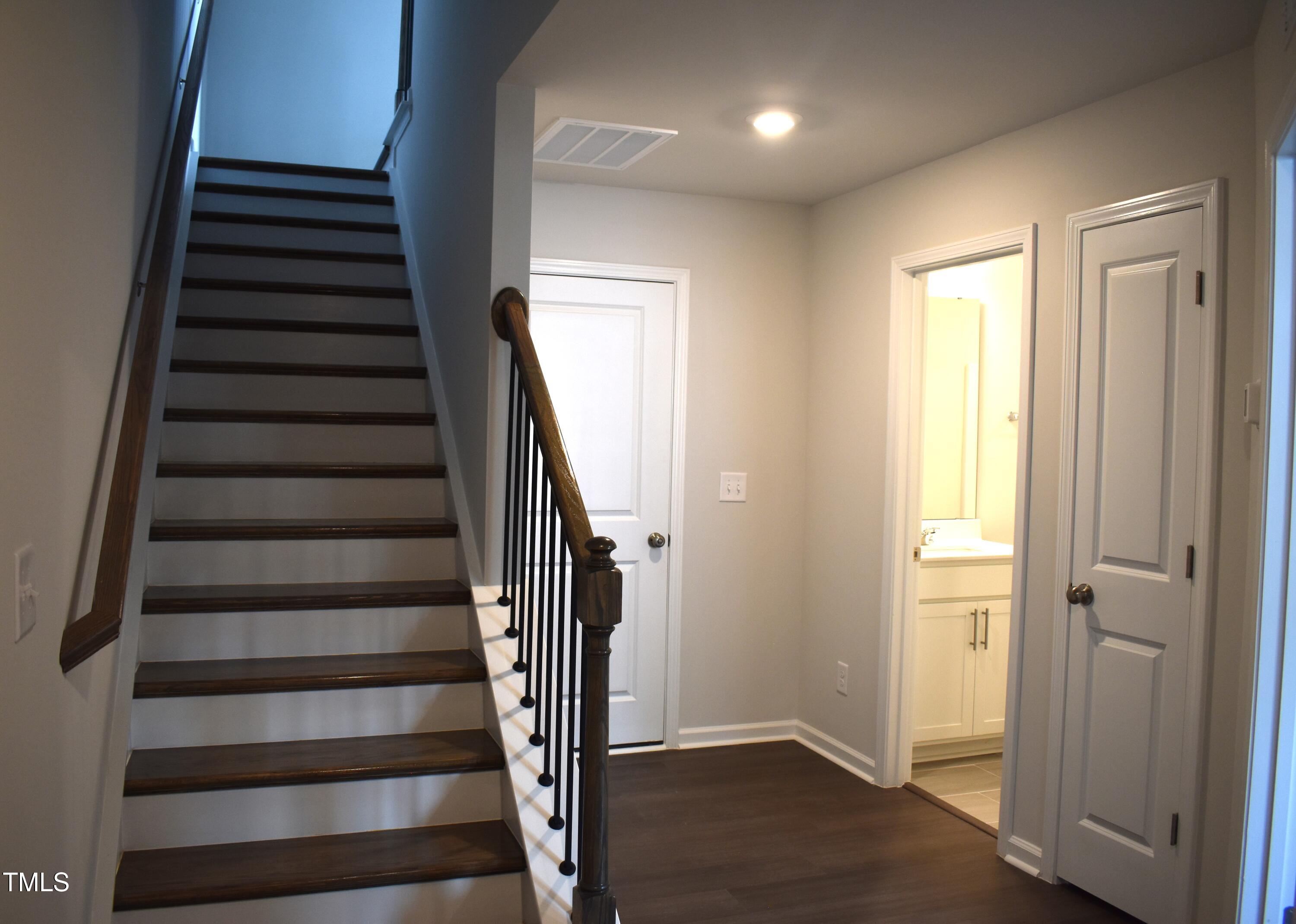 301 Deercroft Drive Apex, NC 27539 - Photo 4 of 33 a view of entryway with wooden floor and windows