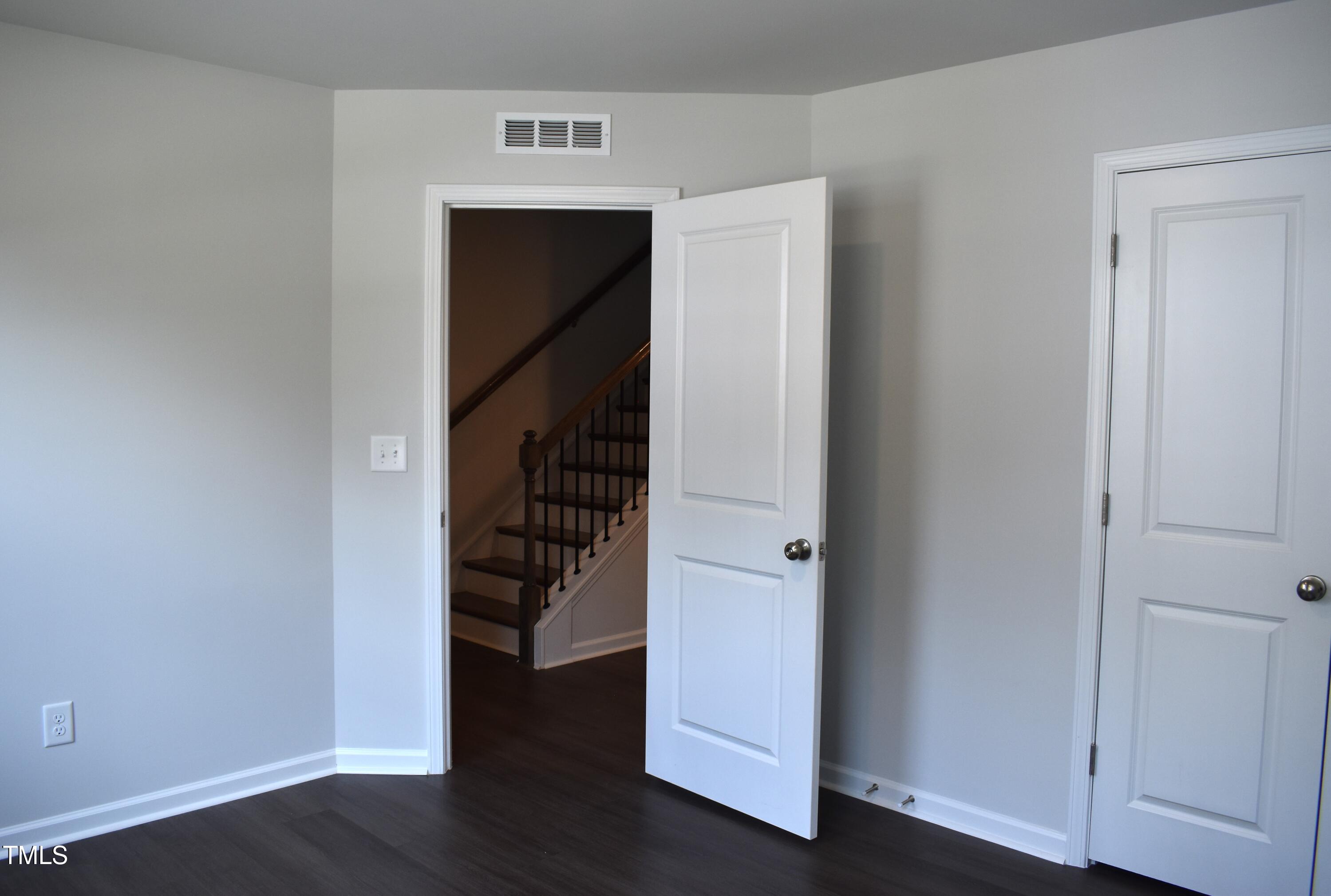 301 Deercroft Drive Apex, NC 27539 - Photo 5 of 33 a view of a hallway with wooden floor and entryway
