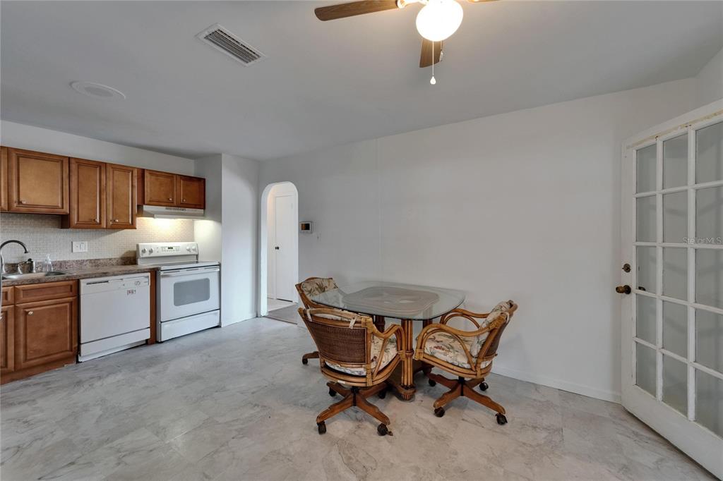 8818 Ashman Road Riverview, FL 33578 - Photo 12 of 26 a kitchen with stainless steel appliances kitchen island granite countertop furniture and a refrigerator