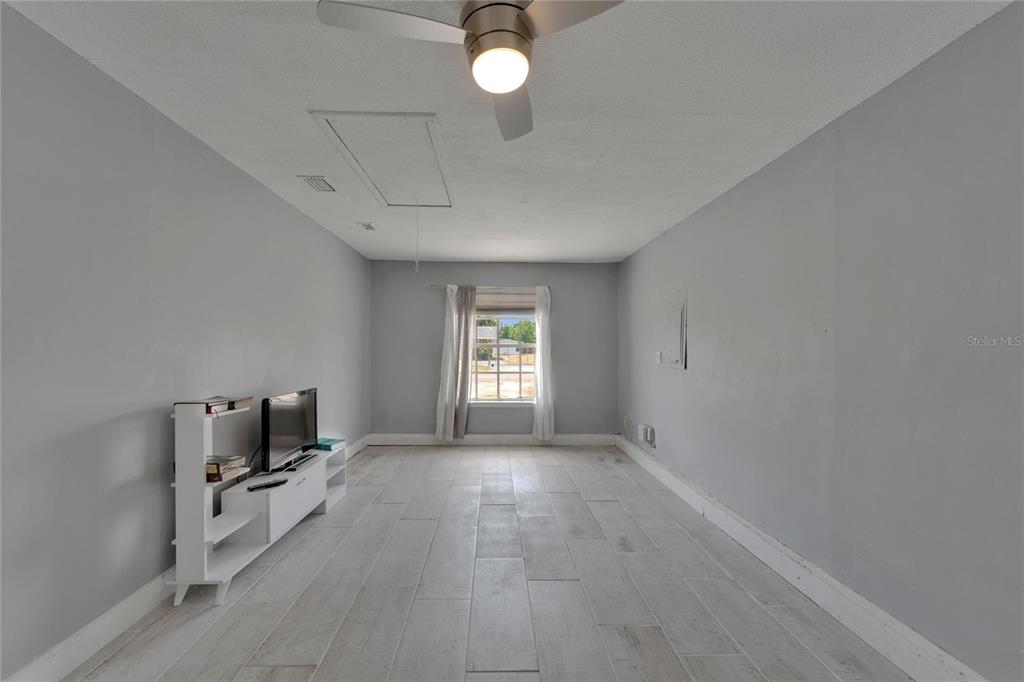 8818 Ashman Road Riverview, FL 33578 - Photo 13 of 26 a view of room with window and hardwood floor