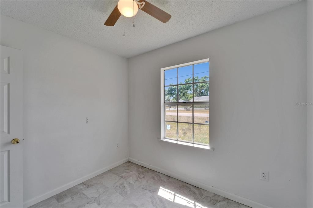8818 Ashman Road Riverview, FL 33578 - Photo 17 of 26 an empty room with a window