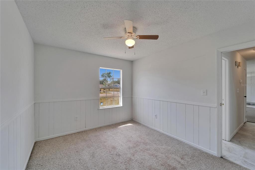 8818 Ashman Road Riverview, FL 33578 - Photo 20 of 26 an empty room with windows and closet