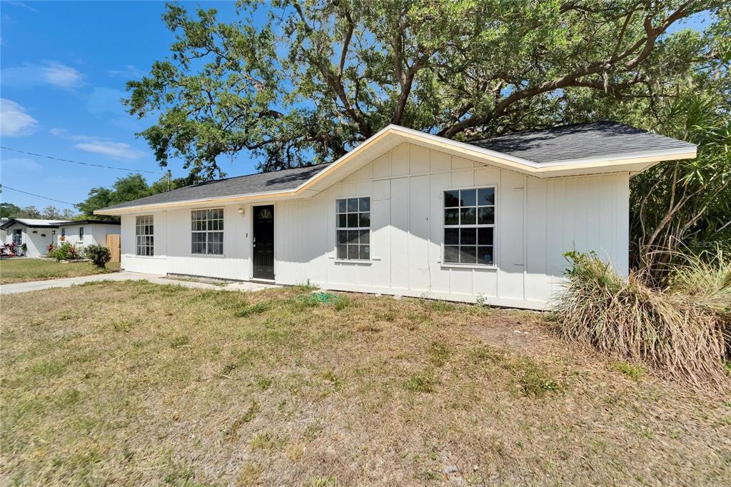 8818 Ashman Road Riverview, FL 33578 - Photo 6 of 26 a house with trees in the background