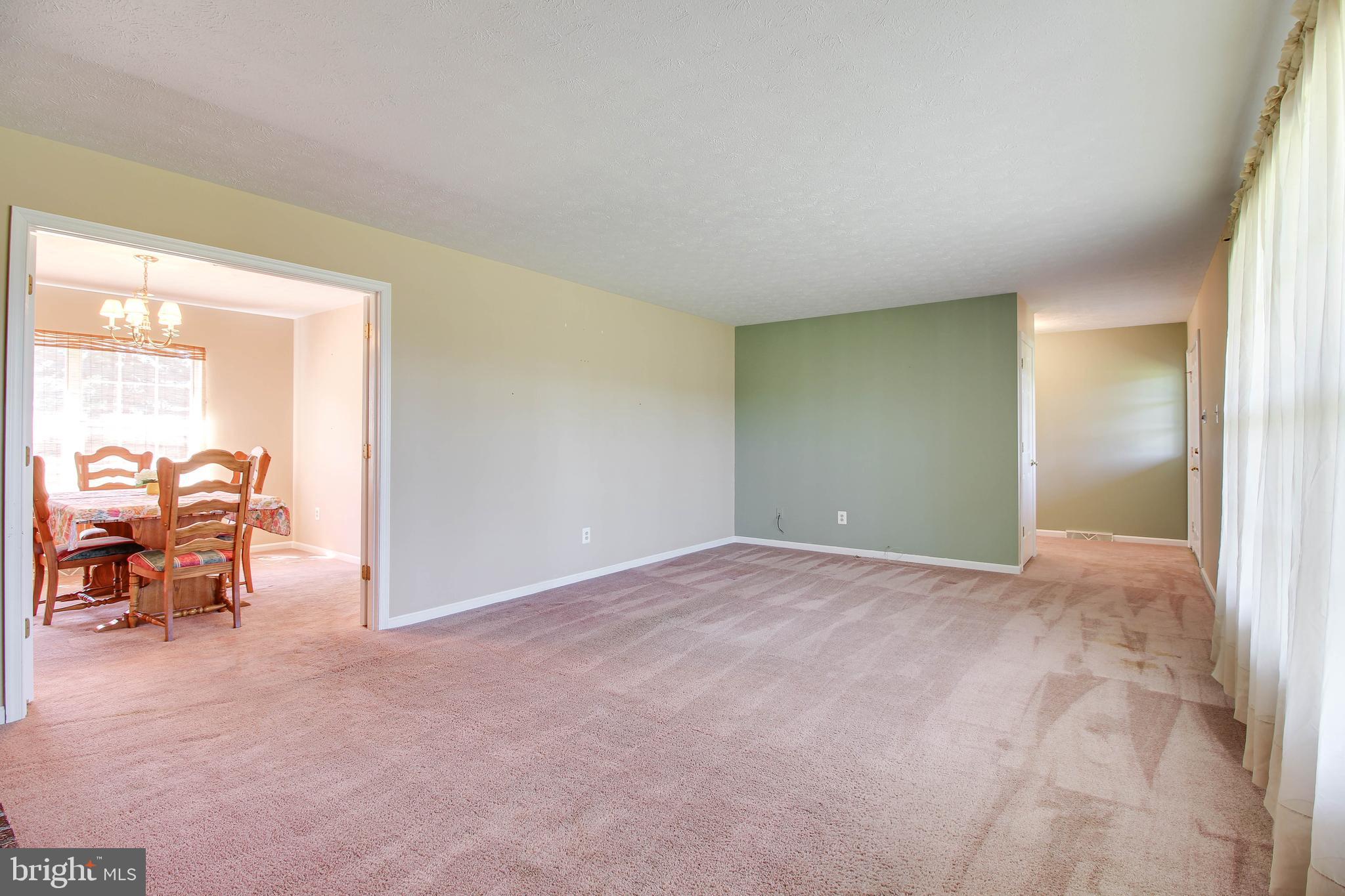 4709 Mt Carmel Road Hampstead, MD 21074 - Photo 4 of 44 an empty room with furniture and a window