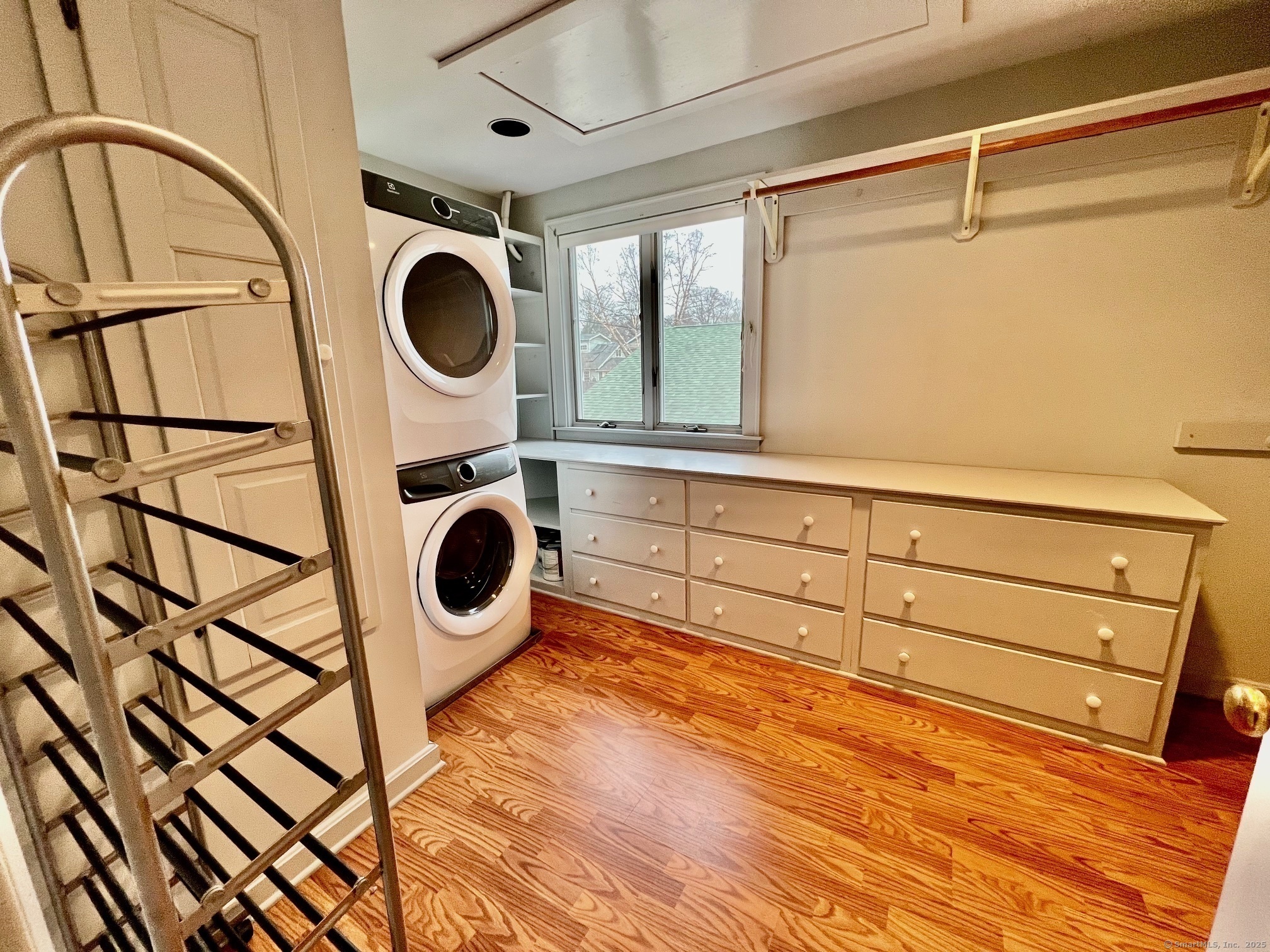23 Linden Lane Madison, CT 06443 - Photo 16 of 30 Primary bedroom has a large, walk-in closet. It is also where the washer and dryer are housed.
