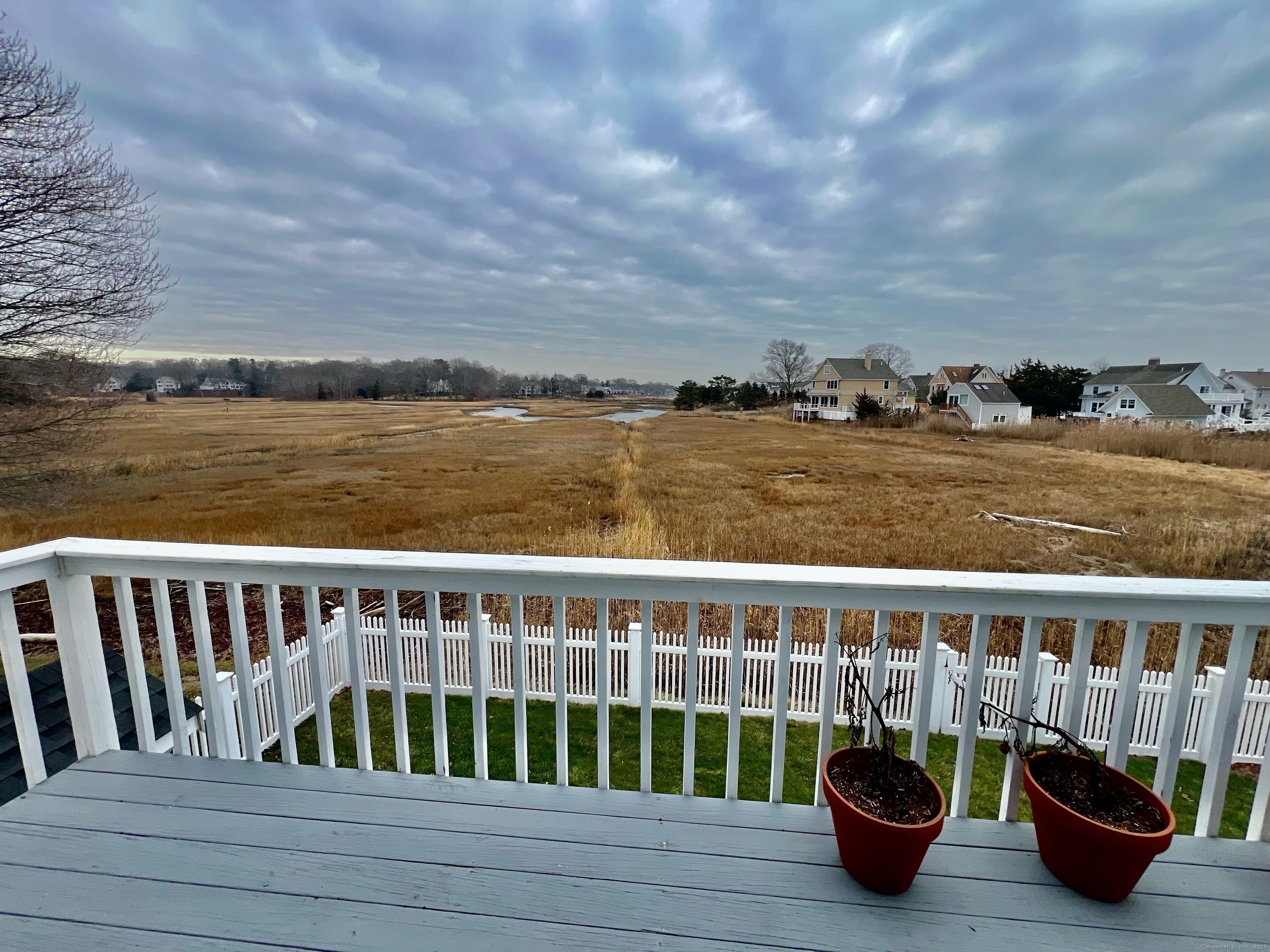 23 Linden Lane Madison, CT 06443 - Photo 17 of 30 The Primary Bedroom has a balcony overlooking the marsh, a perfect place to enjoy your morning coffee or just sit and relax at the end of your day.