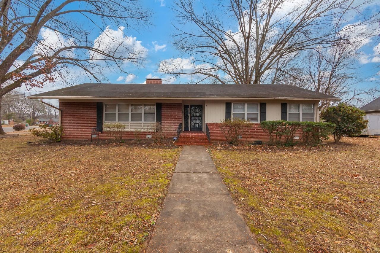 203 South Fairgrounds Street Jackson, TN 38301 - Photo 10 of 13 a front view of a house with a yard and potted plants
