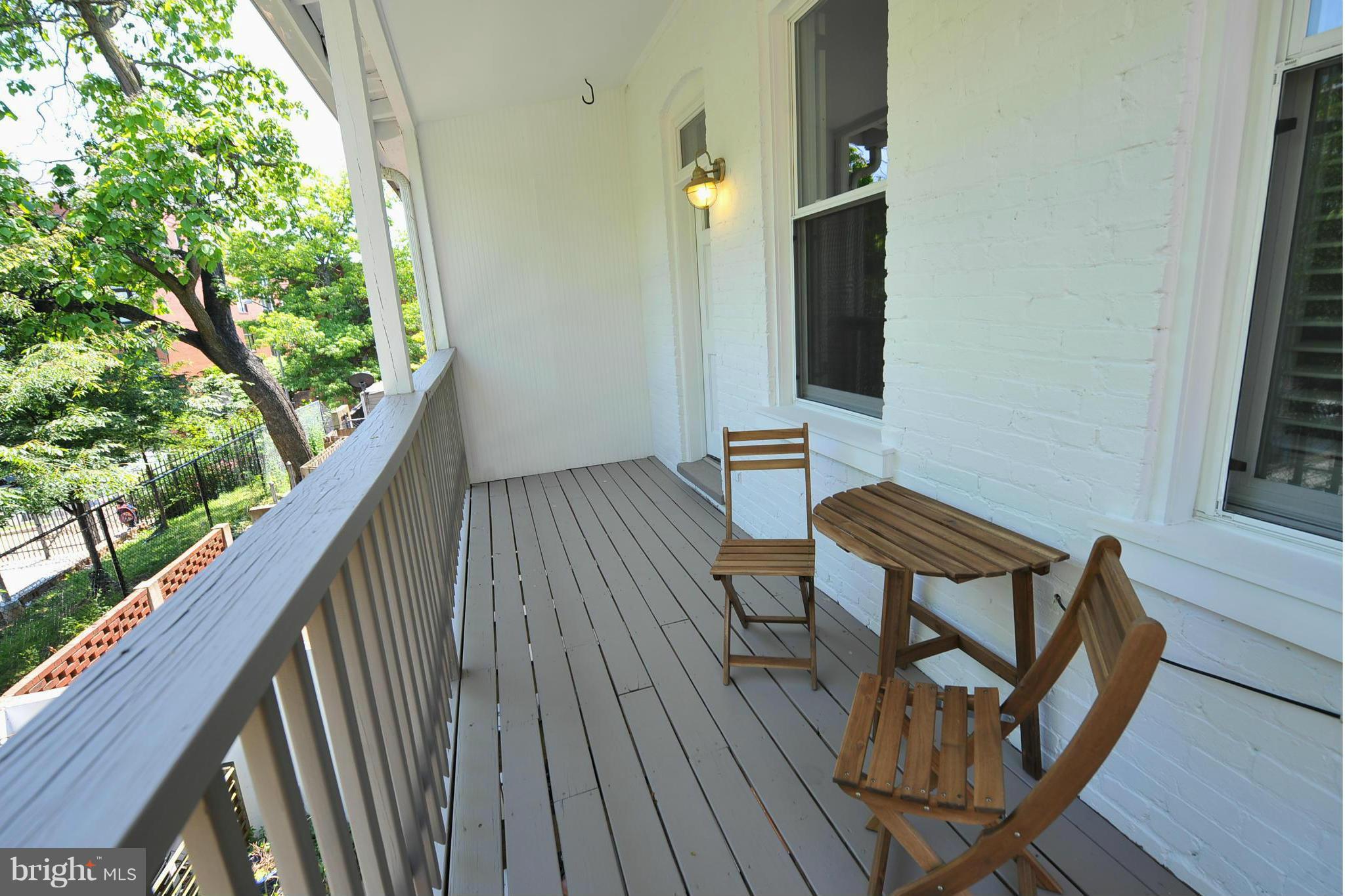 2509 17th Street Northwest, Unit 3 Washington, DC 20009 - Photo 17 of 27 a balcony with wooden floor and outdoor seating