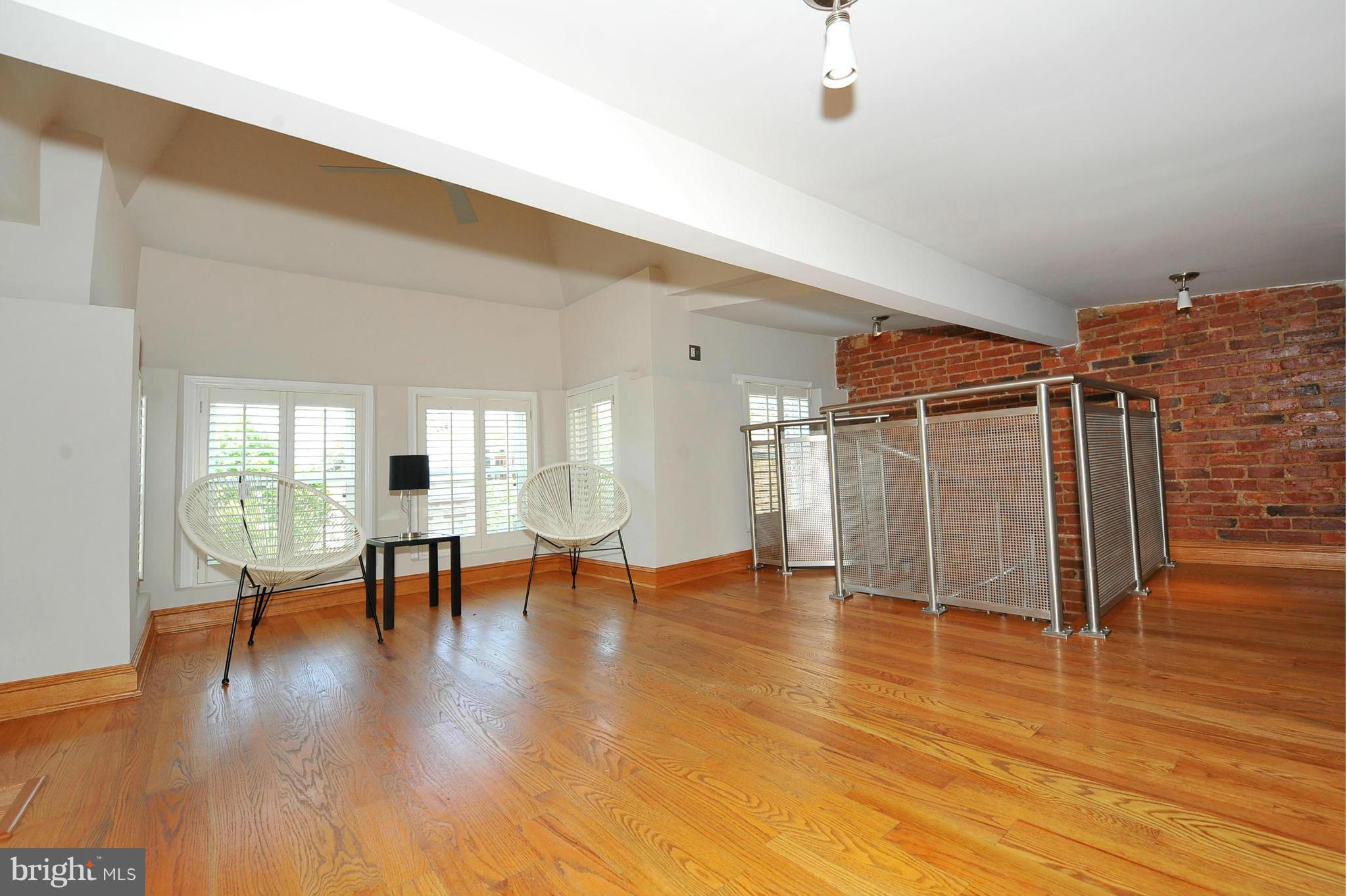 2509 17th Street Northwest, Unit 3 Washington, DC 20009 - Photo 21 of 27 a view of empty room with wooden floor and fan
