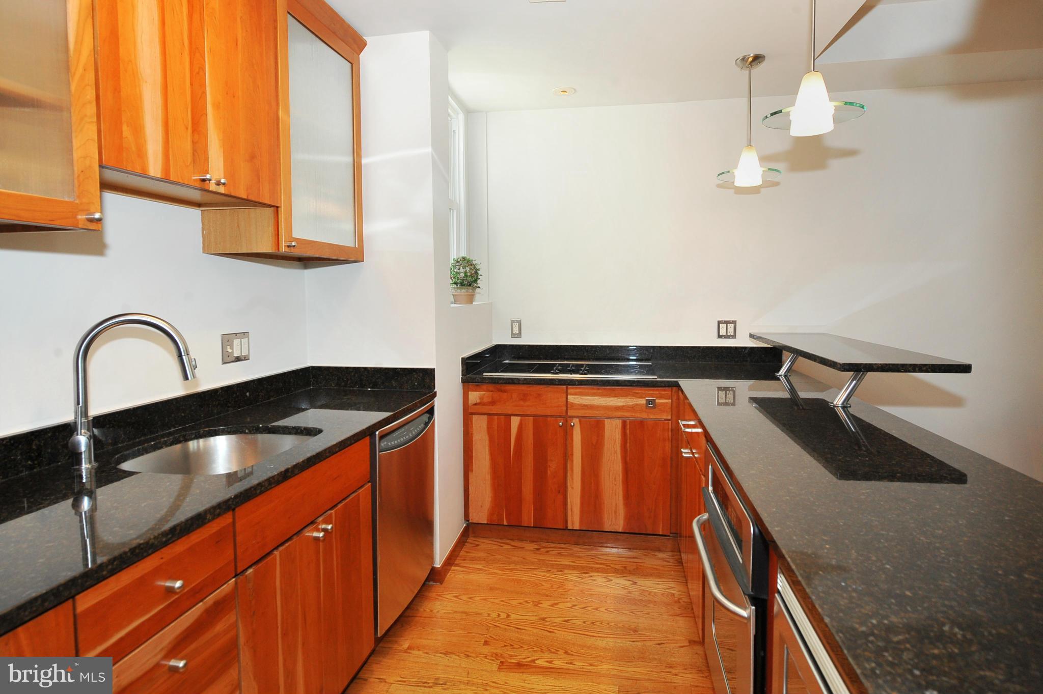 2509 17th Street Northwest, Unit 3 Washington, DC 20009 - Photo 4 of 27 a kitchen with stainless steel appliances granite countertop a sink and cabinets