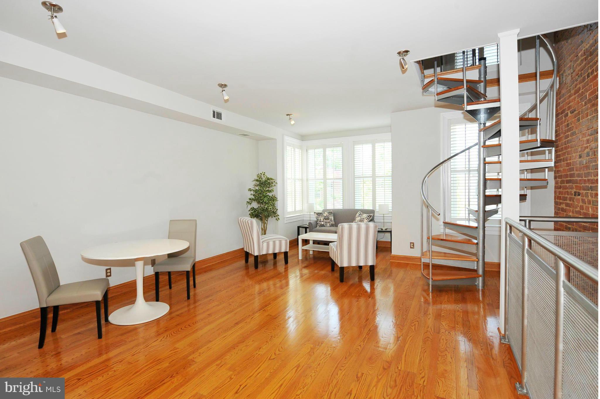 2509 17th Street Northwest, Unit 3 Washington, DC 20009 - Photo 5 of 27 a living room with couches chairs and kitchen view with wooden floor