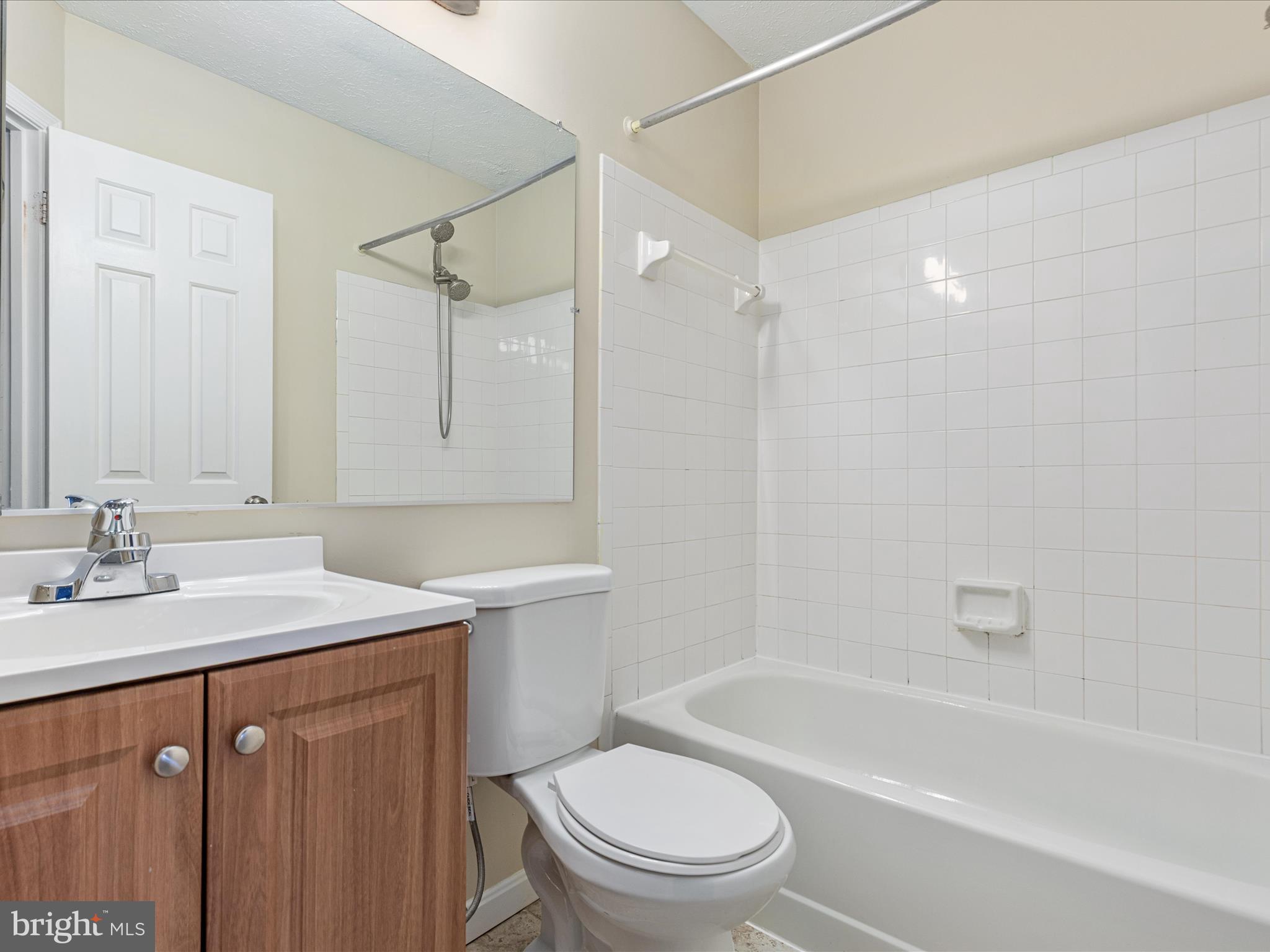 7219 Kousa Lane Springfield, VA 22152 - Photo 14 of 34 a bathroom with a sink a toilet and shower