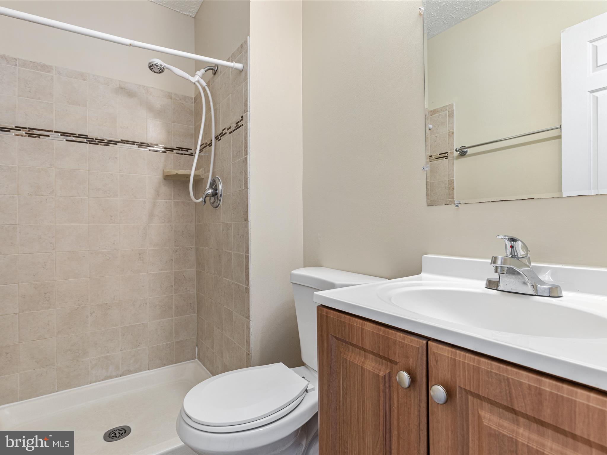 7219 Kousa Lane Springfield, VA 22152 - Photo 18 of 34 a bathroom with a sink a toilet and shower