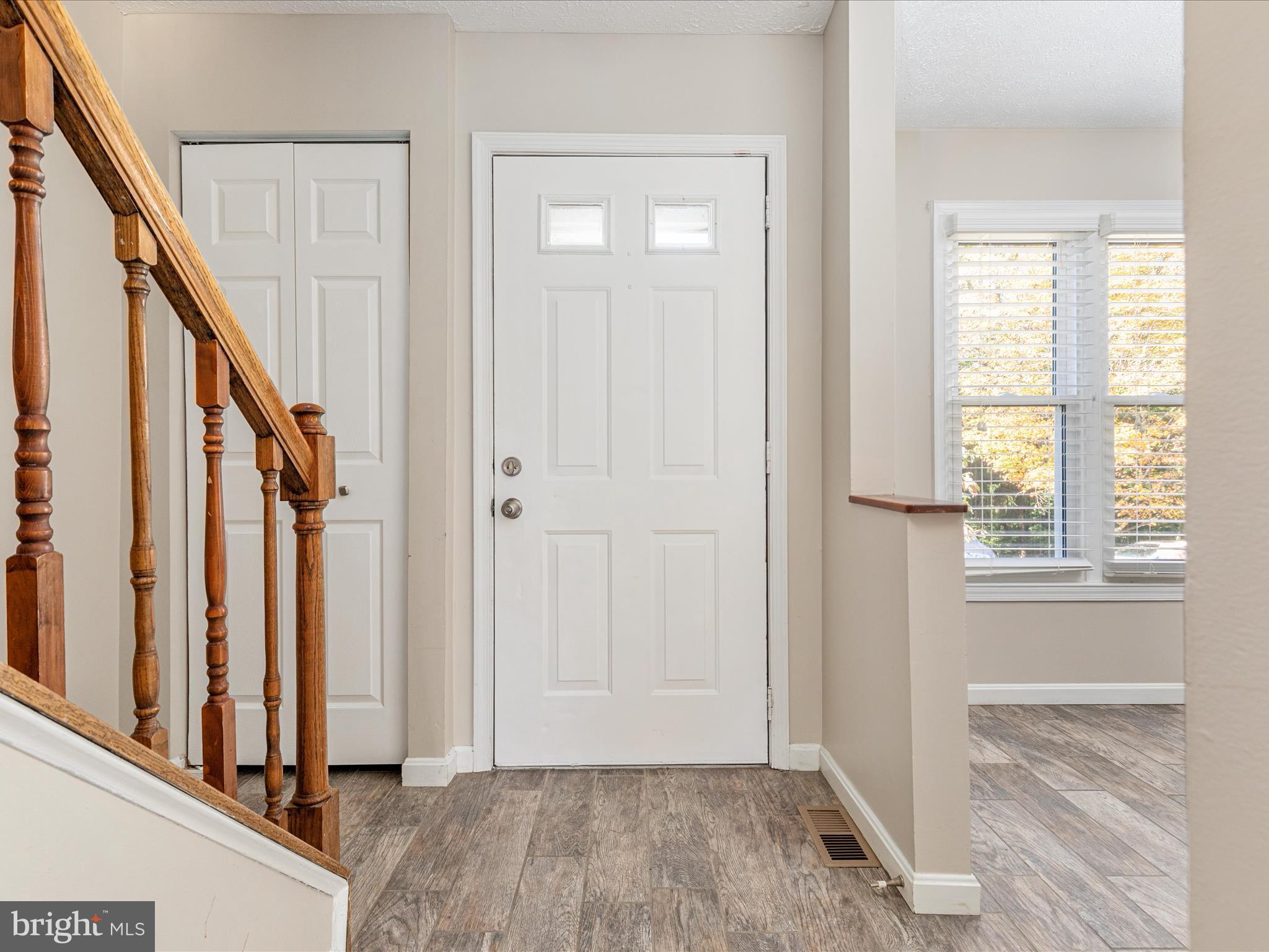 7219 Kousa Lane Springfield, VA 22152 - Photo 2 of 34 an entryway with wooden floor and staircase