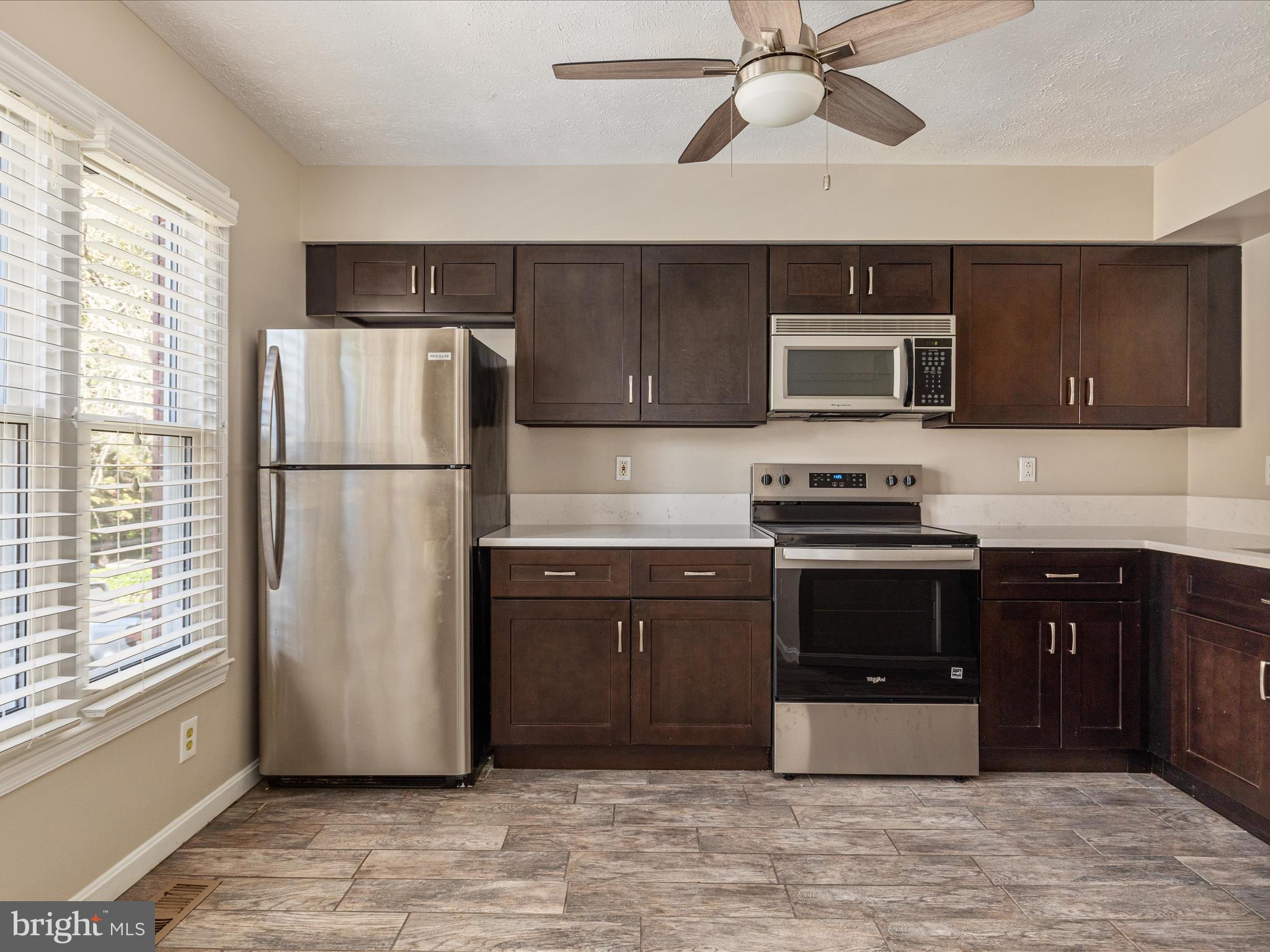 7219 Kousa Lane Springfield, VA 22152 - Photo 4 of 34 a kitchen with a refrigerator and a microwave