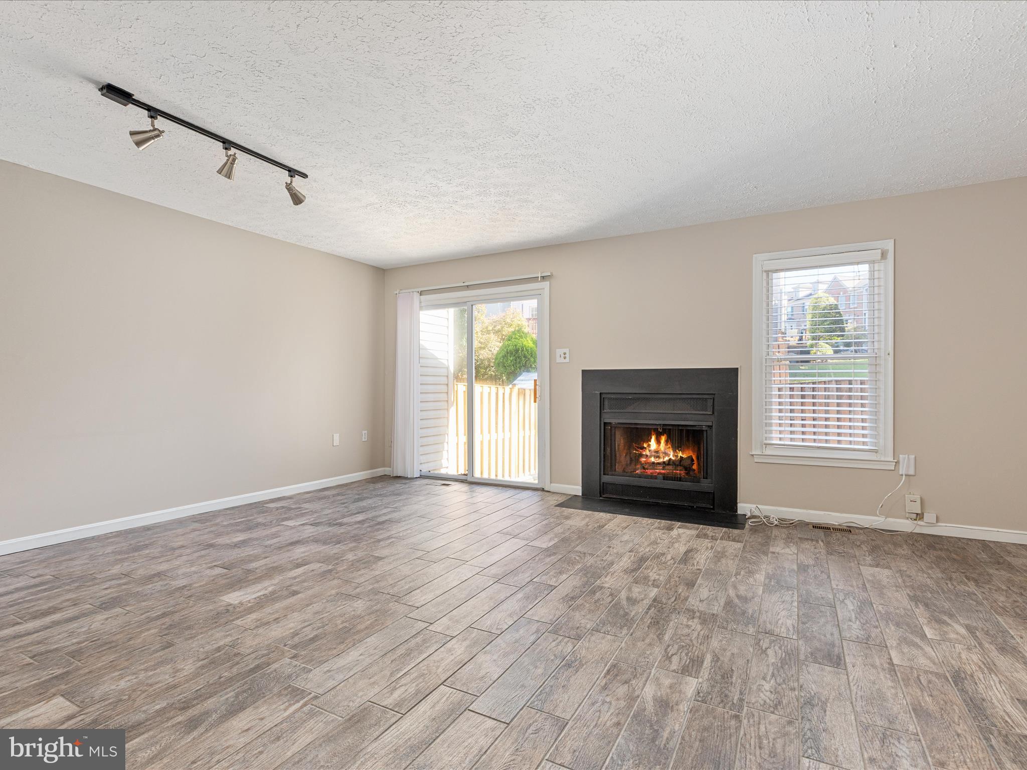7219 Kousa Lane Springfield, VA 22152 - Photo 8 of 34 a view of an empty room with a window and fireplace