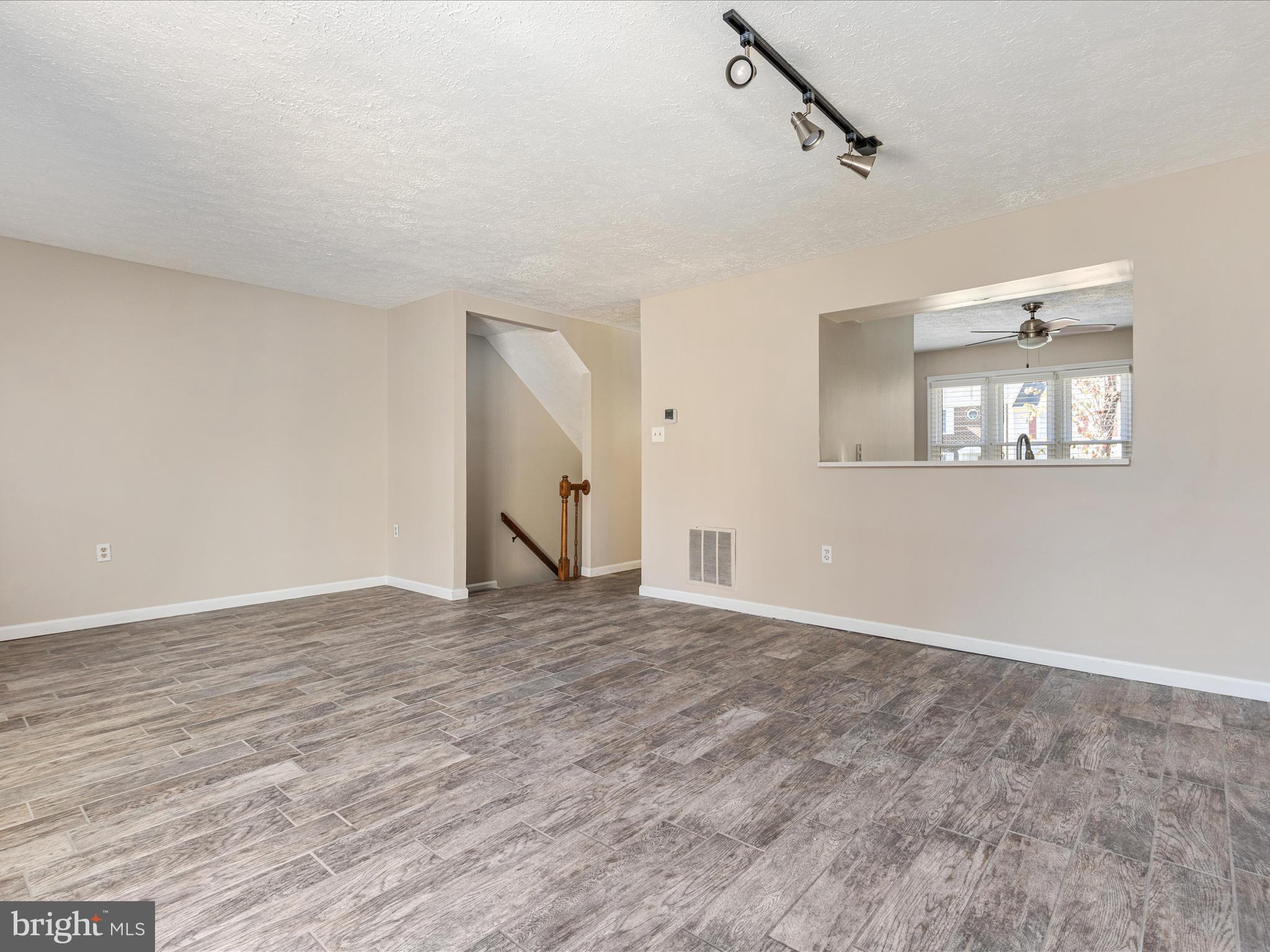7219 Kousa Lane Springfield, VA 22152 - Photo 10 of 34 a view of an empty room with wooden floor and a window