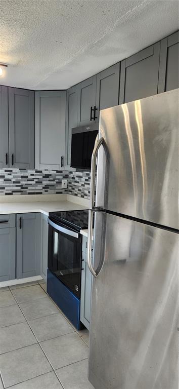 5507 Riddle Road Holiday, FL 34690 - Photo 16 of 18 a kitchen with stainless steel appliances a refrigerator sink and cabinets