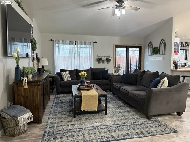 a living room with furniture and a chandelier