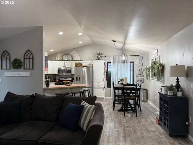 a living room with lots of furniture and kitchen view