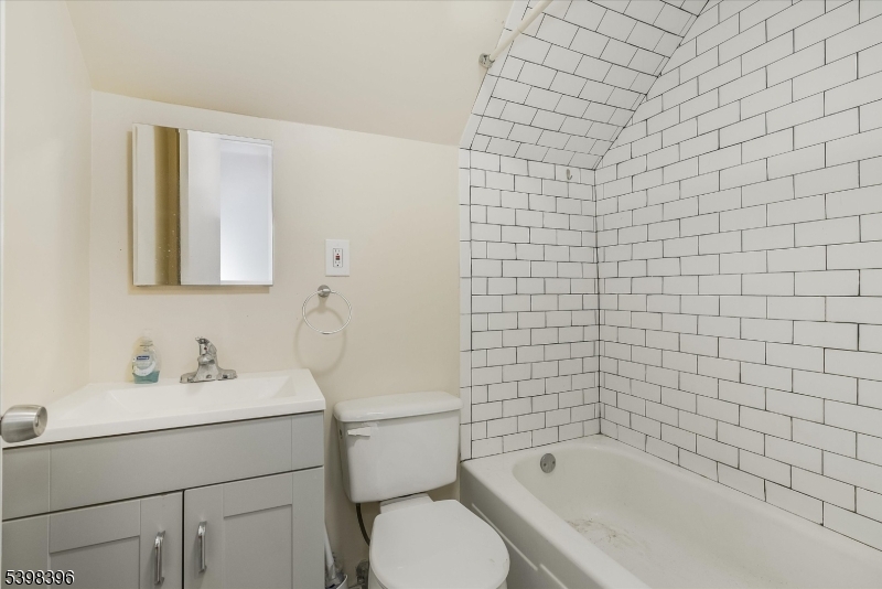 46 James Street, Unit 2 Montclair, NJ 07042 - Photo 17 of 22 a bathroom with a sink mirror toilet and bathtub
