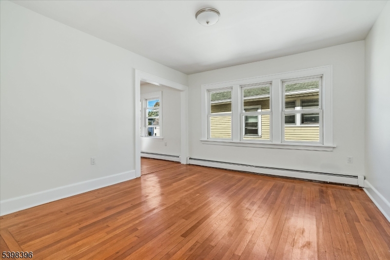 46 James Street, Unit 2 Montclair, NJ 07042 - Photo 8 of 22 an empty room with wooden floor and windows