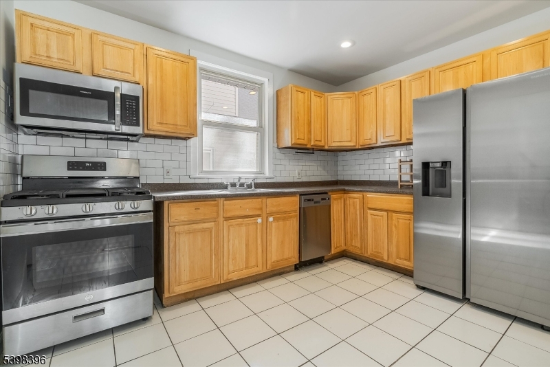 46 James Street, Unit 2 Montclair, NJ 07042 - Photo 10 of 22 a kitchen with stainless steel appliances granite countertop a stove a sink and a microwave